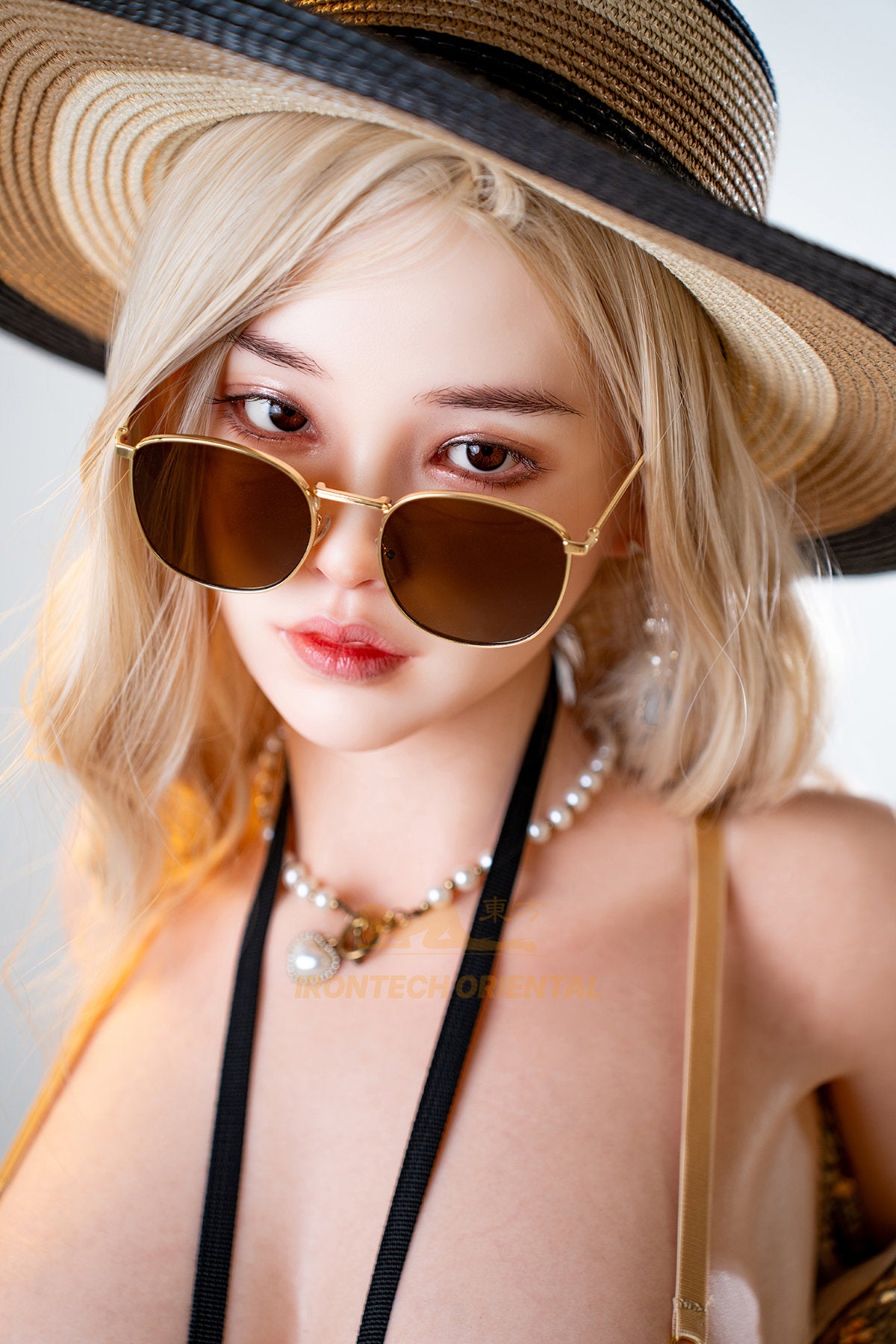 Irontech Doll 158T E Oriental Series Silicone – Eileen close-up portrait in a wide-brim straw hat, round sunglasses, and a pearl necklace, off-shoulder styling