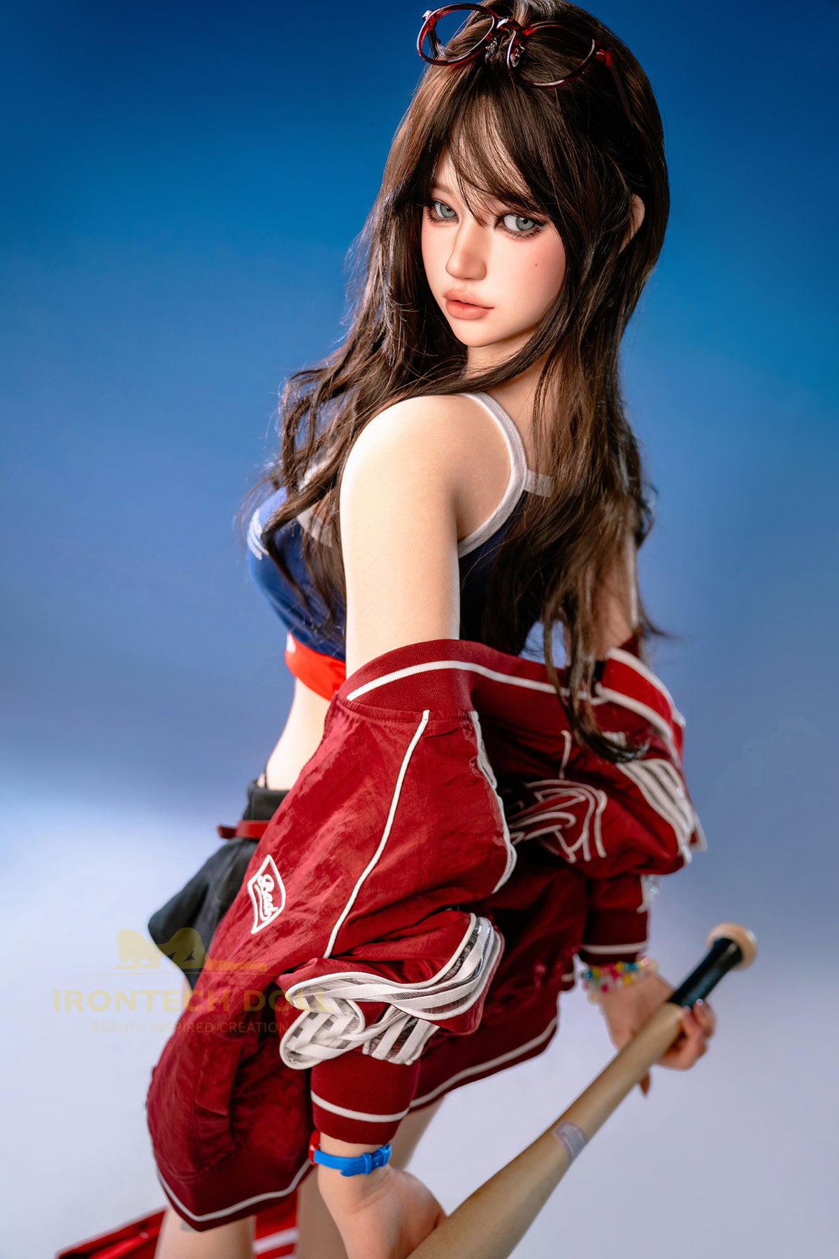 Irontech Doll 161 CM F Silicone - Evie full body three-quarter view in red and blue racing outfit with cap, showcasing realistic 161cm silicone figure proportions and craftsmanship detail