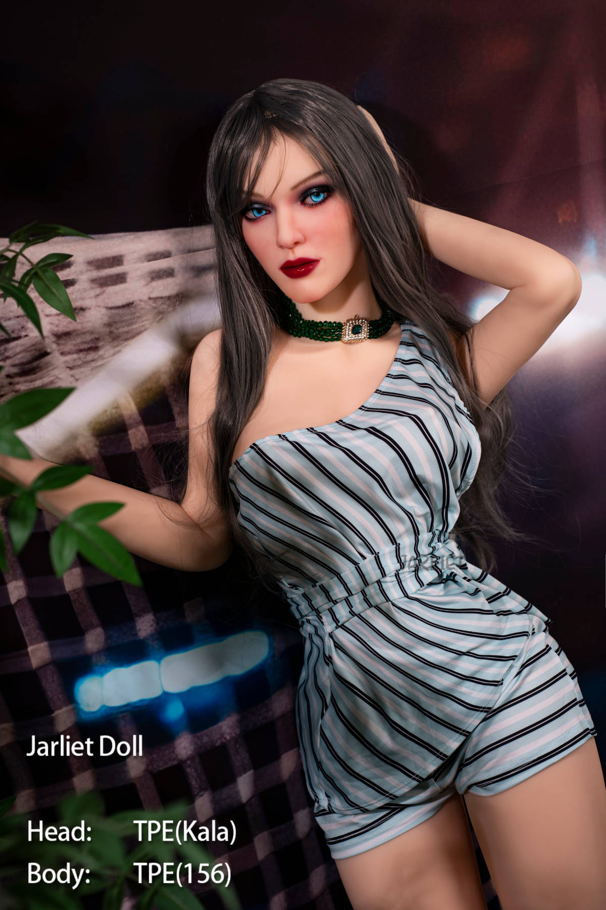 Jarliet Doll 156 cm B TPE - Kala V2 standing pose with one arm raised behind her head, striped playsuit, warm stadium-light backdrop