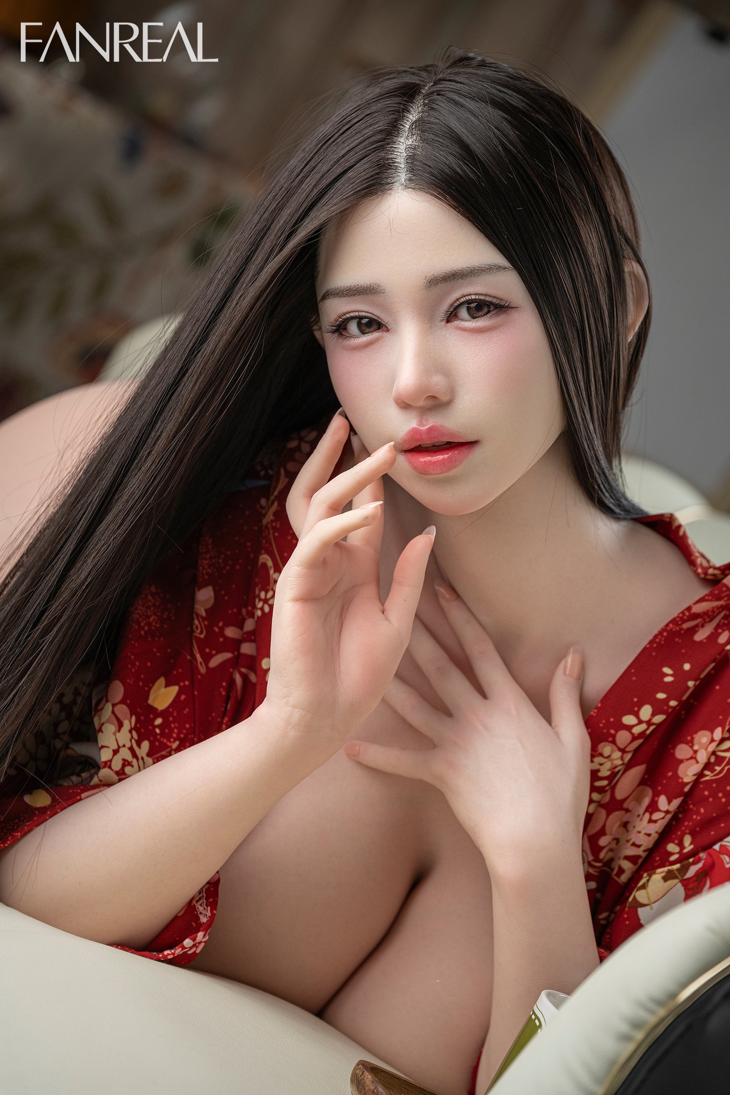 A close-up portrait of the FANREAL DOLL 166 CM J Silicone - Nora V2 featuring long dark hair, soft makeup, and a red floral kimono.