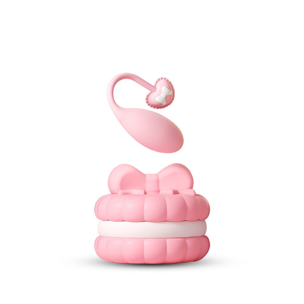 Elegant pink macaron-inspired wearable egg vibrator with remote control and charging base