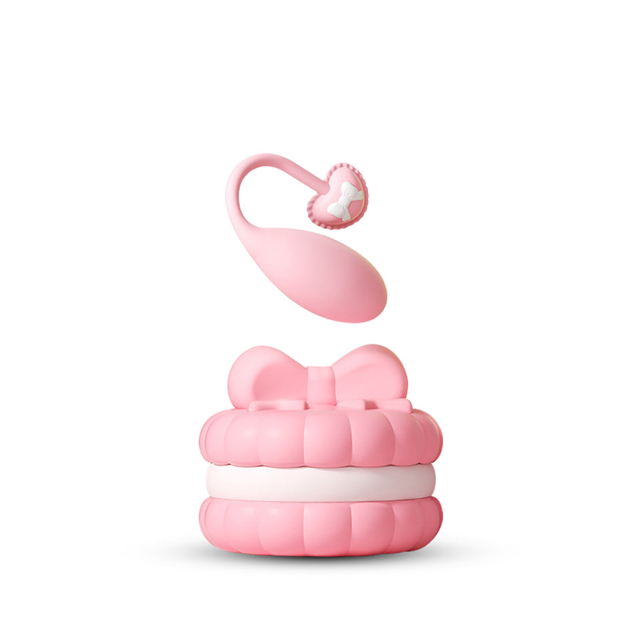 Elegant pink macaron-inspired wearable egg vibrator with remote control and charging base