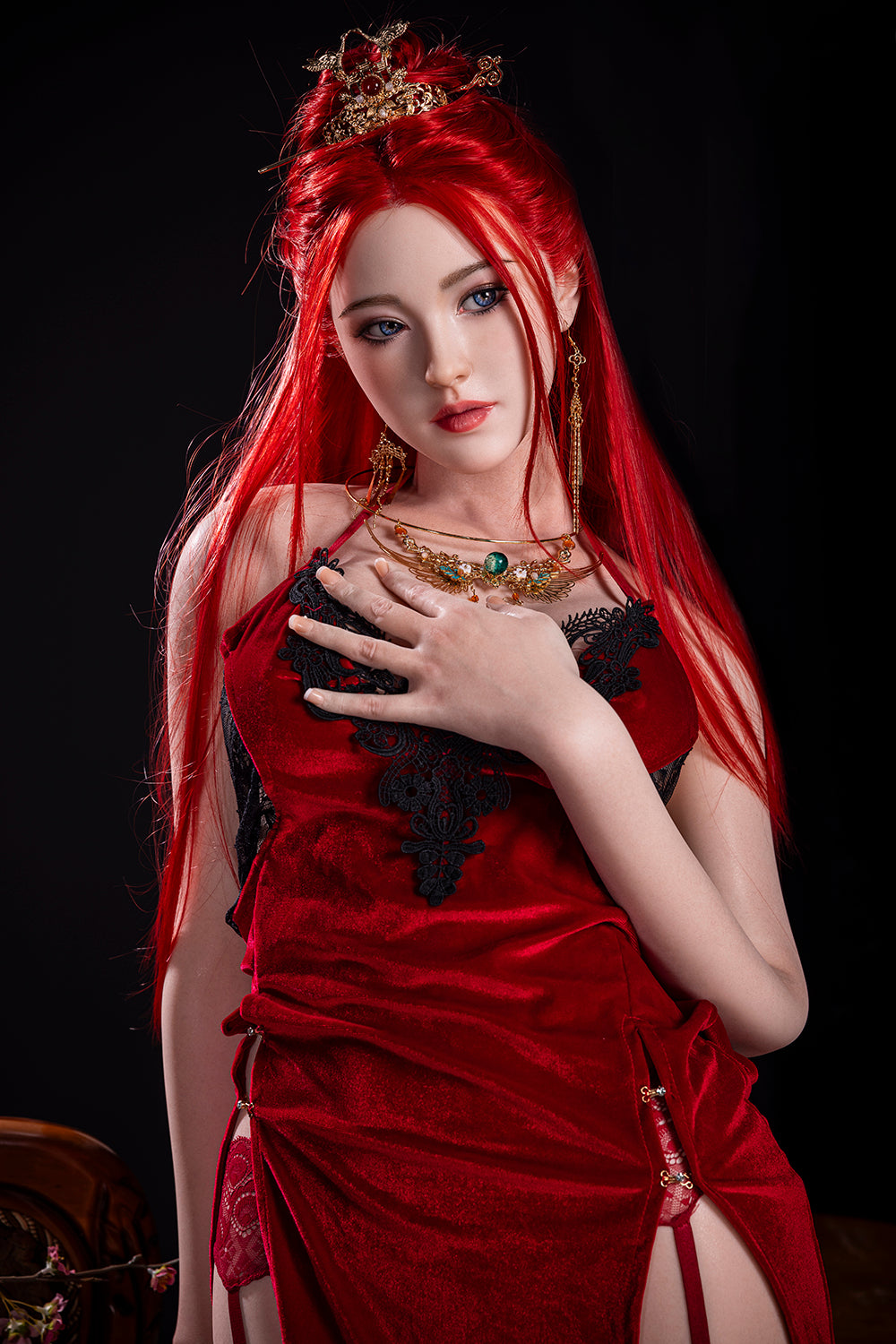 A medium shot of the 169 cm Dache Zheng silicone doll in a red velvet dress, posing with one hand against her chest, showcasing her realistic features and high-contrast red hair.