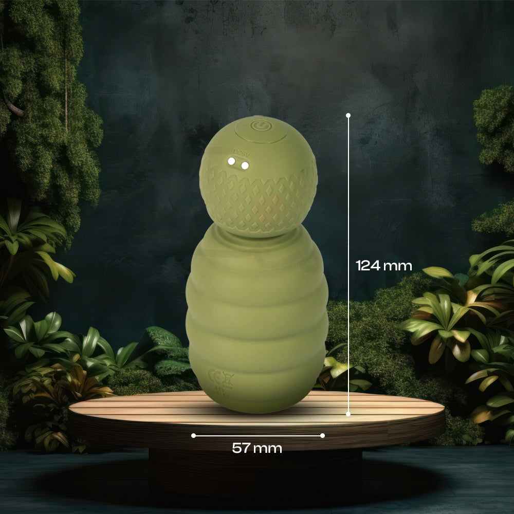 Small green massager shown on platform with size measurements for scale reference