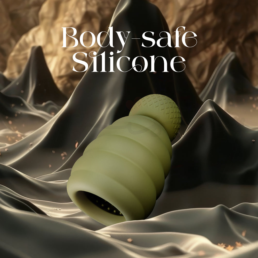Green massager resting on fabric emphasizing smooth body-safe silicone material
