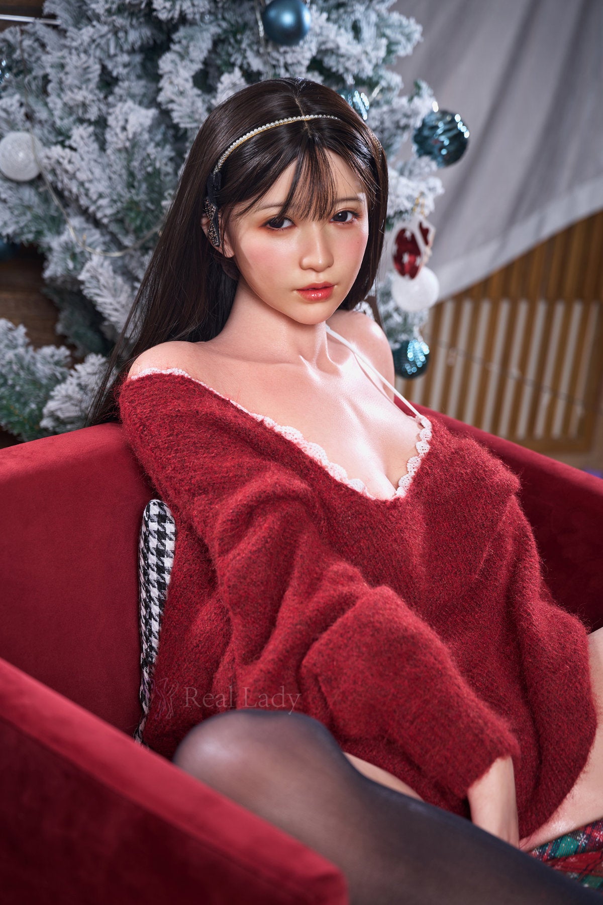 RealLady 159 cm H Silicone - Emilia full body standing pose in red velvet dress with black fur trim and black stockings, long dark hair, festive Christmas background
