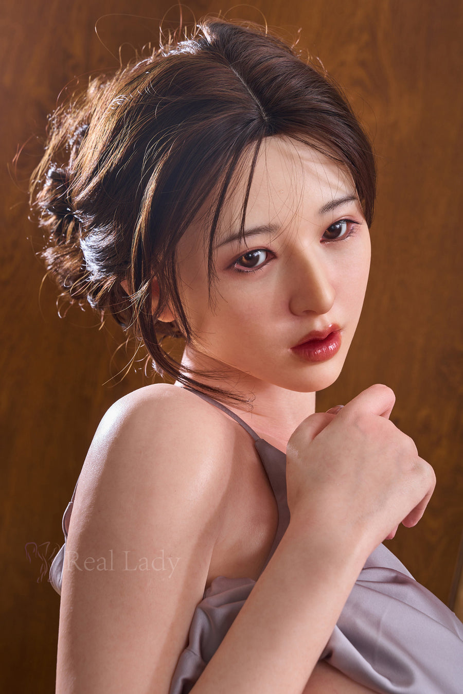 RealLady 159 cm H Silicone - Shizuka close-up upper body shot in grey satin slip dress with floral hair accessory, dark updo hair, warm wooden sauna background