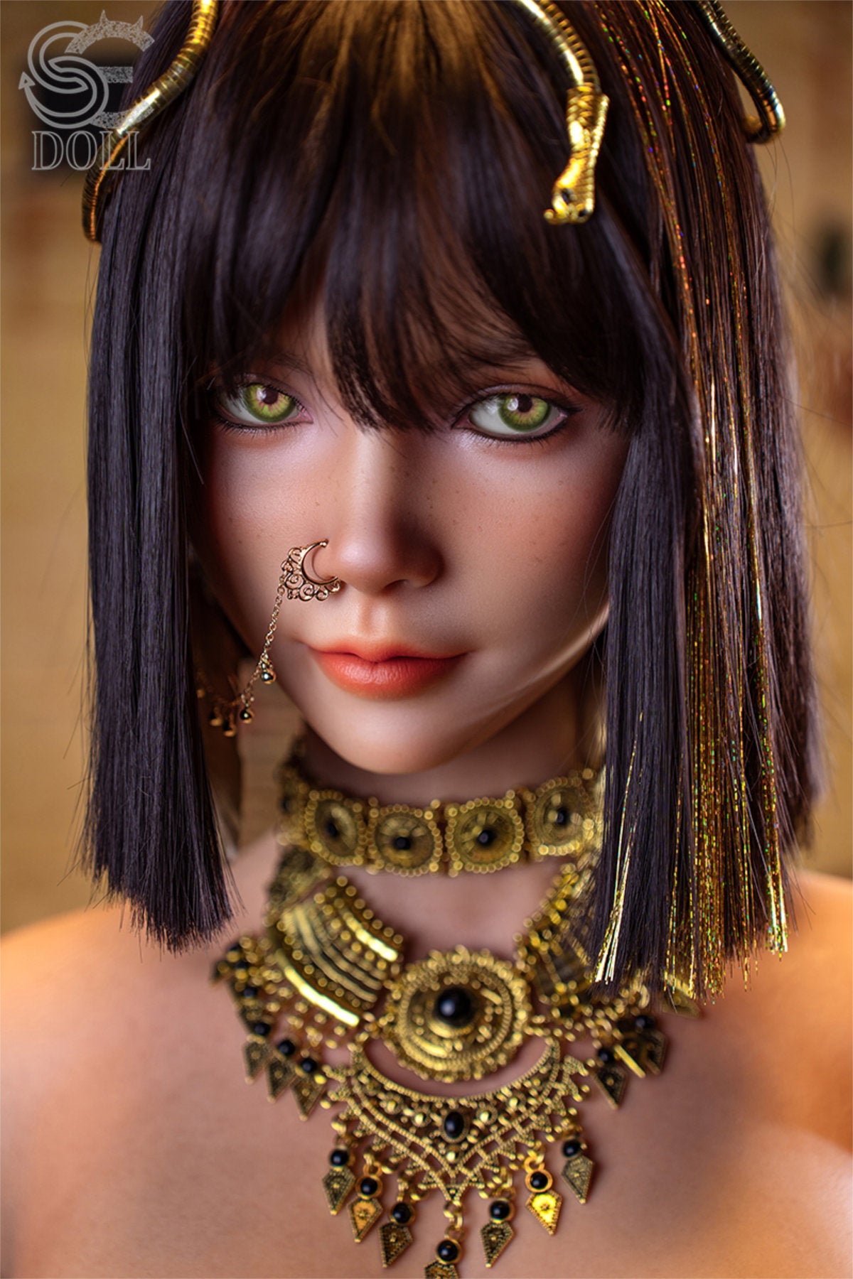 SEDOLL T111 cm G Silicone Torso - Kemeny.C upper body front view in gold Egyptian-style collar necklace and black strappy harness, short dark hair with gold braided accessories, warm temple background
