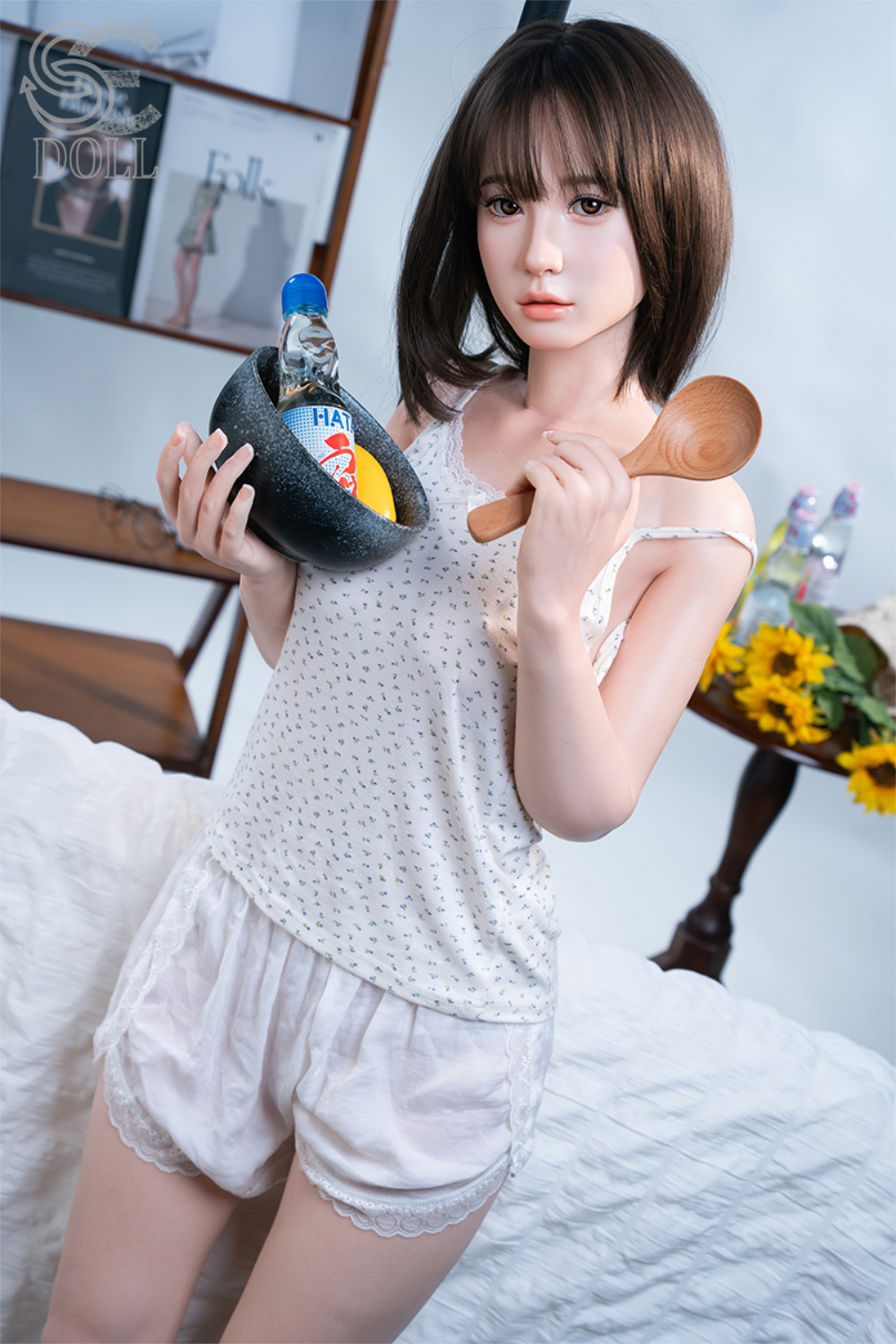 SEDOLL T153 cm A Aya Series Silicone - Hinata.A V2 holding a Spoon and a bottle of water in a room setting.