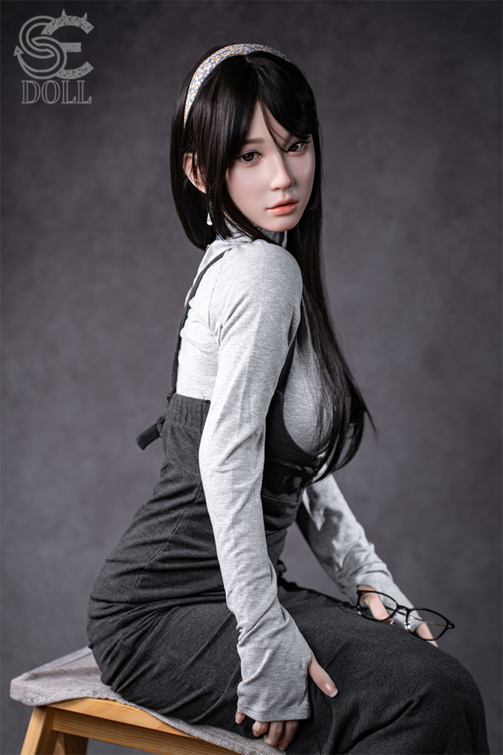 SEDOLL T153 cm A Aya Series Silicone - Hinata.A wearing a gray outfit with suspenders sitting on a bench.
