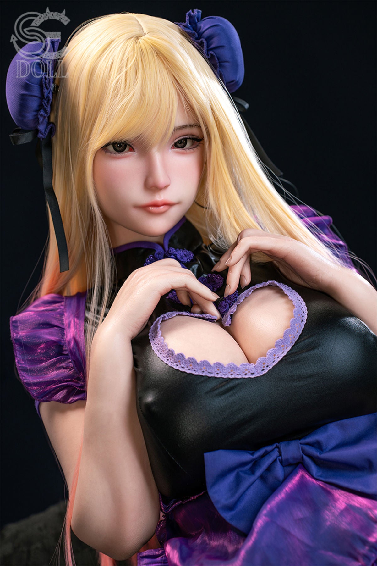 SEDOLL T155 cm J Silicone Pro - Yuuki.M close-up portrait, long blonde hair, blue eyes, black and purple gothic dress with a heart-shaped chest cutout, hands forming a heart over the cutout, moody dark blue backdrop