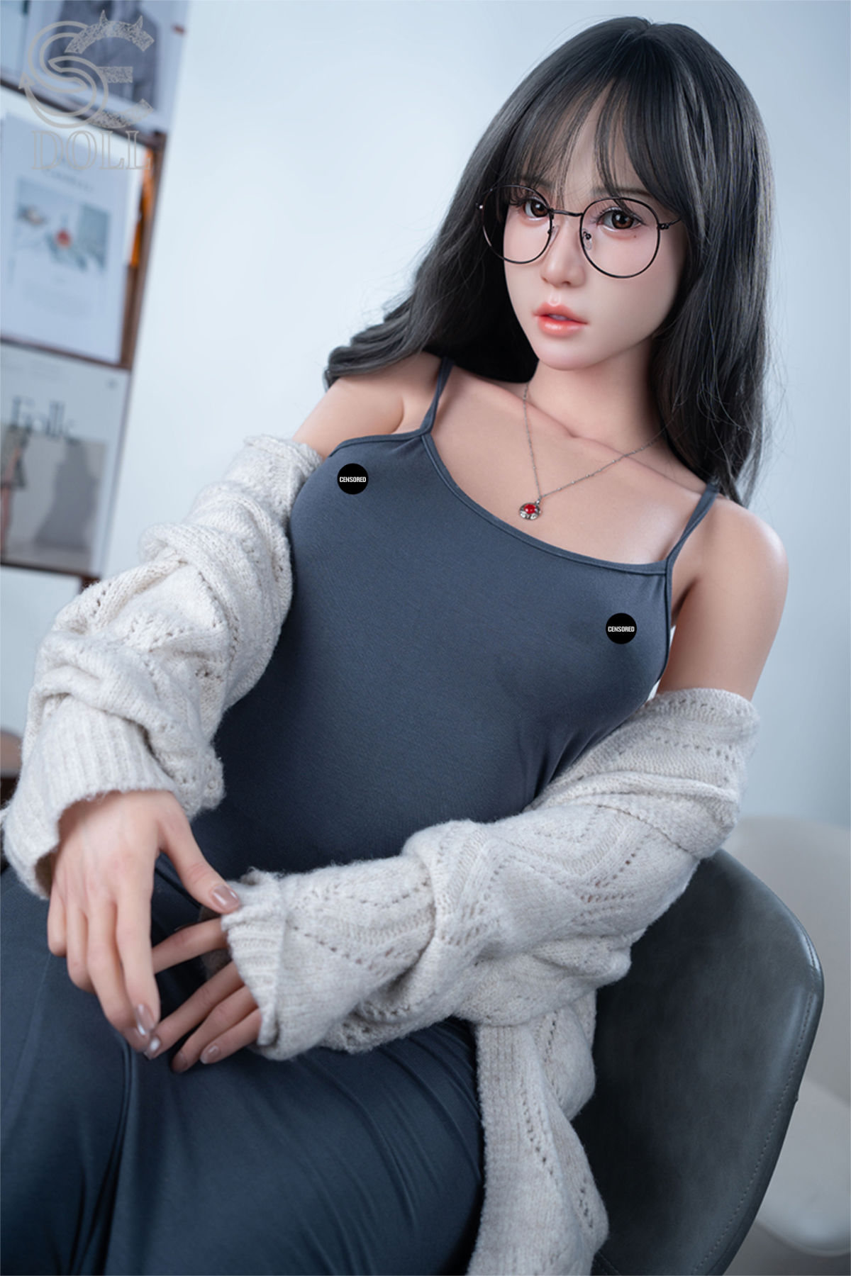 SEDOLL T160 cm C Aya Series Silicone - Sena.A wearing a gray dress and white cardigan sitting on a chair.