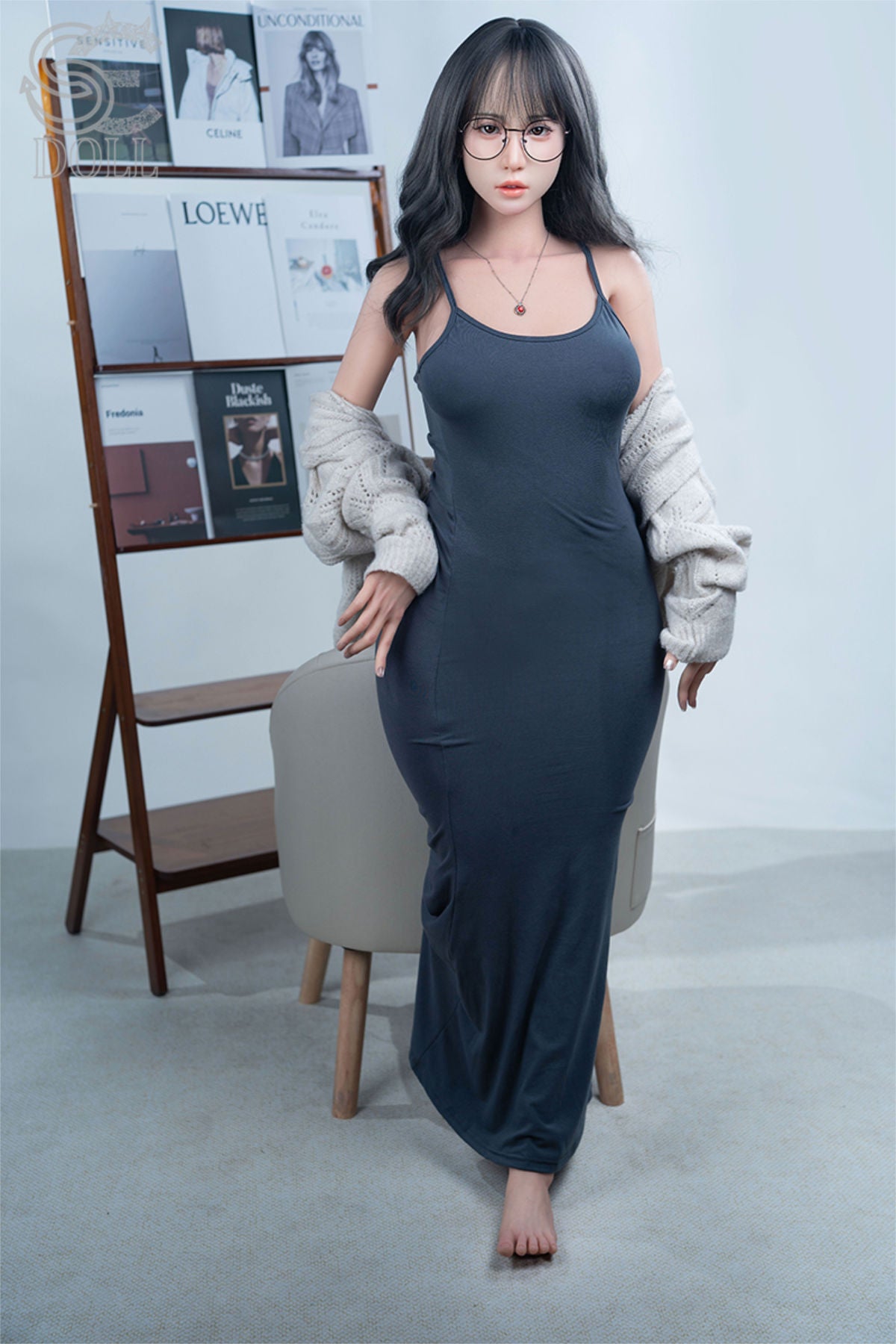 SEDOLL T160 cm C Aya Series Silicone - Sena.A in a long dark dress standing in a room with a chair and shelves.