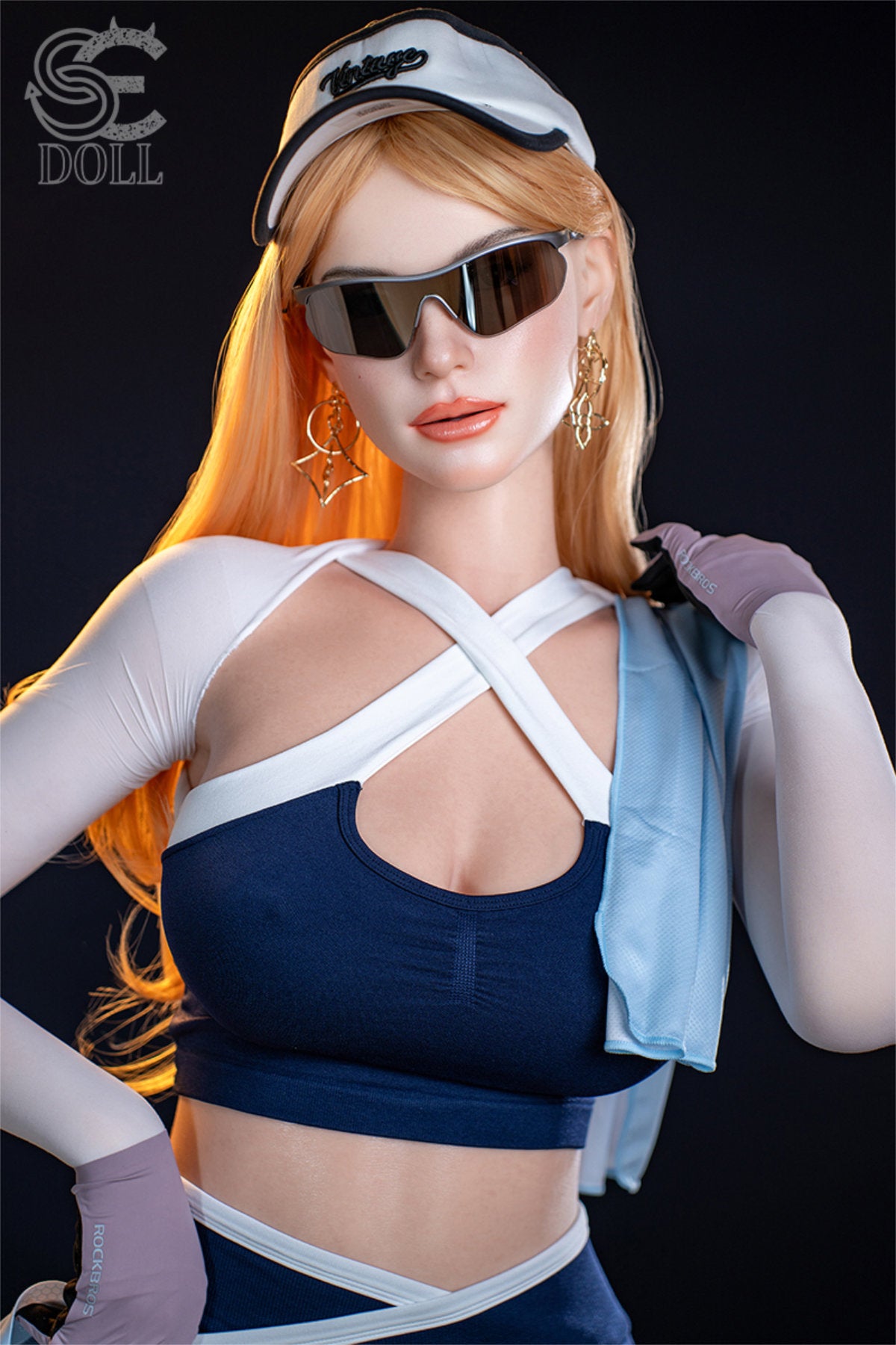 SEDOLL T175 cm E Silicone Pro - Nora.A standing in sunglasses with arm raised, holding the helmet aloft, navy harness top