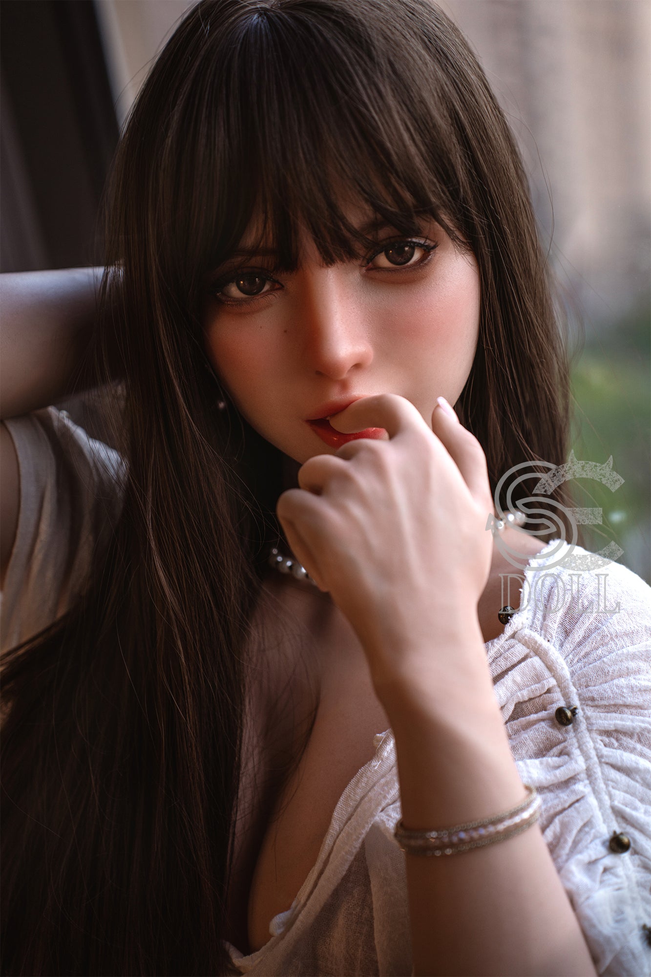 SEDOLL T165 cm C Silicone Pro - Annika.J with long dark hair and bangs, wearing a white top, sitting indoors.