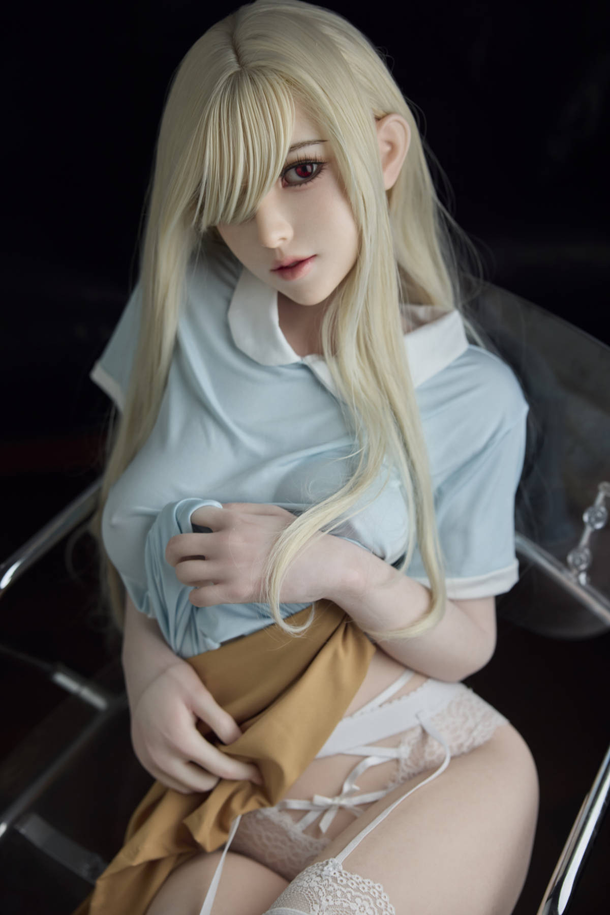 Starpery 151 cm B - Chuye – seated on a black chair in a blue dress and white thigh-high stockings