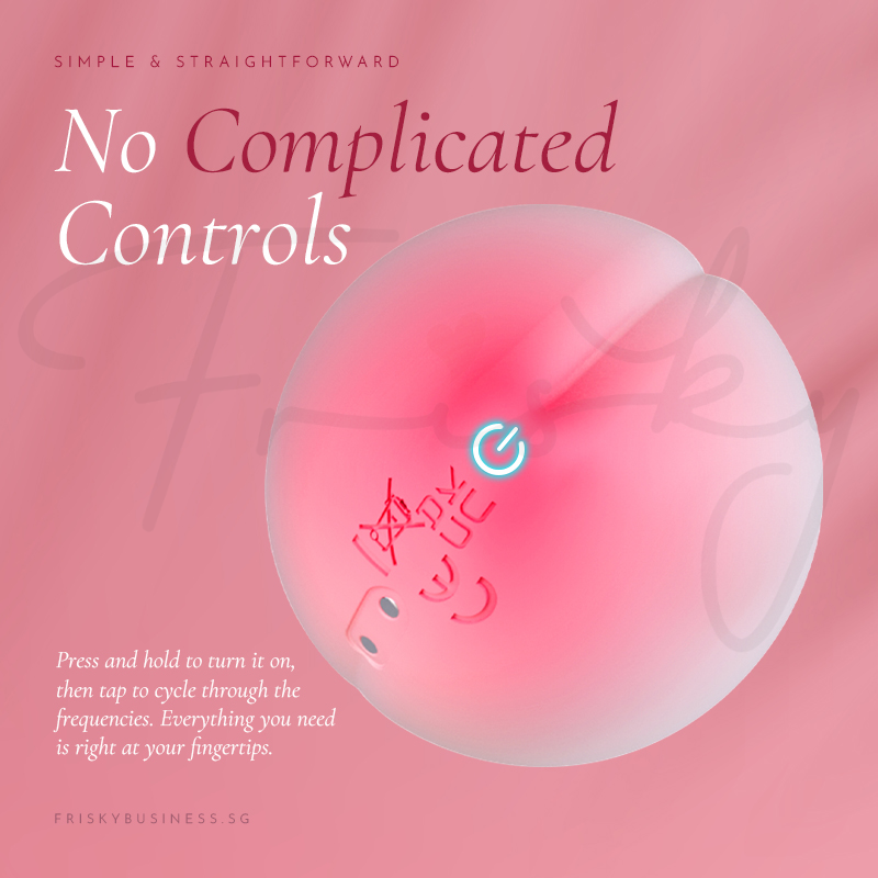Close-up of the single control button on a pink background