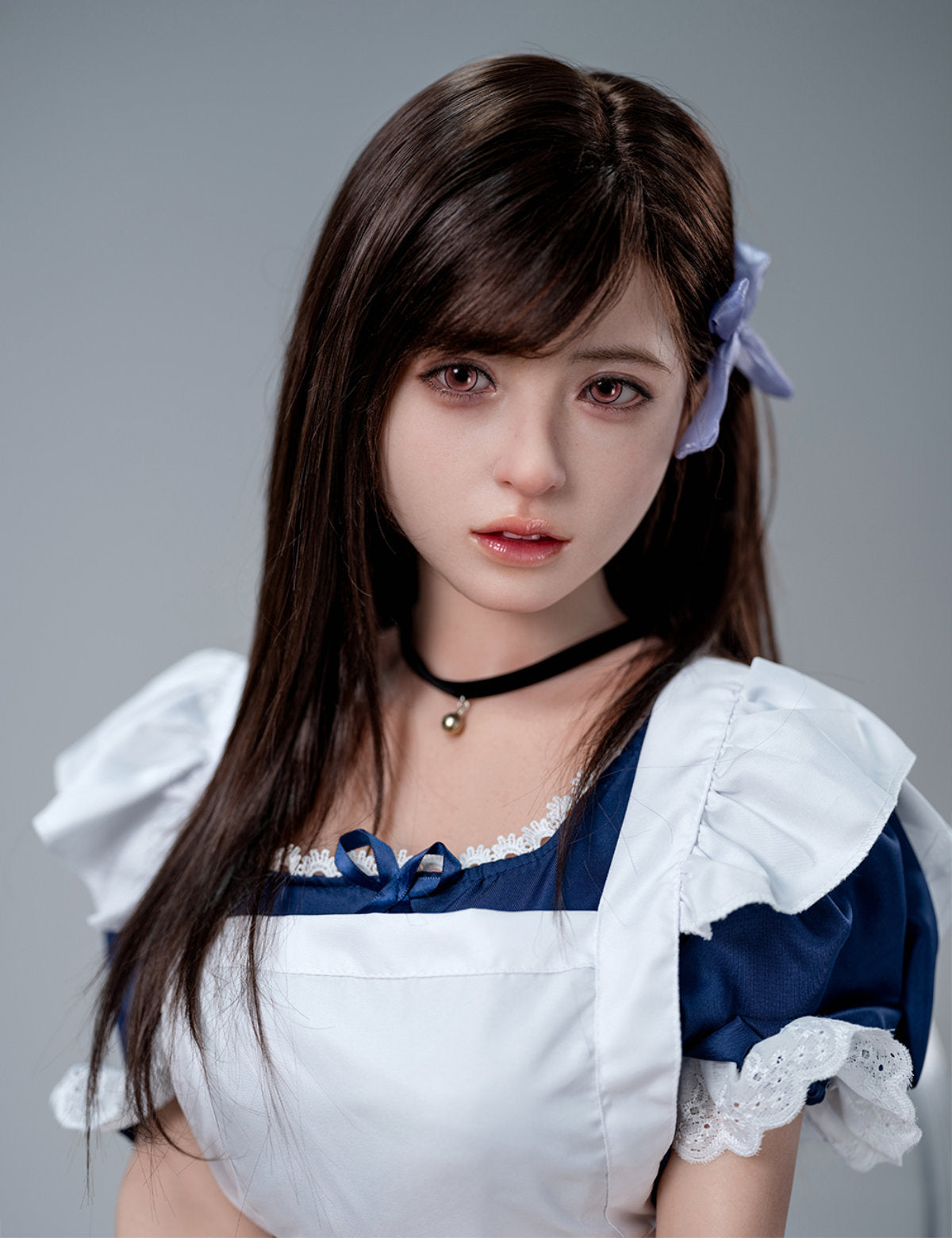 Close-up portrait of the TOP-CYDOLL 157cm D-Cup Koharu Realistic Sex Doll with long dark hair and a purple hair bow, dressed in a classic blue and white maid outfit with a black choker.