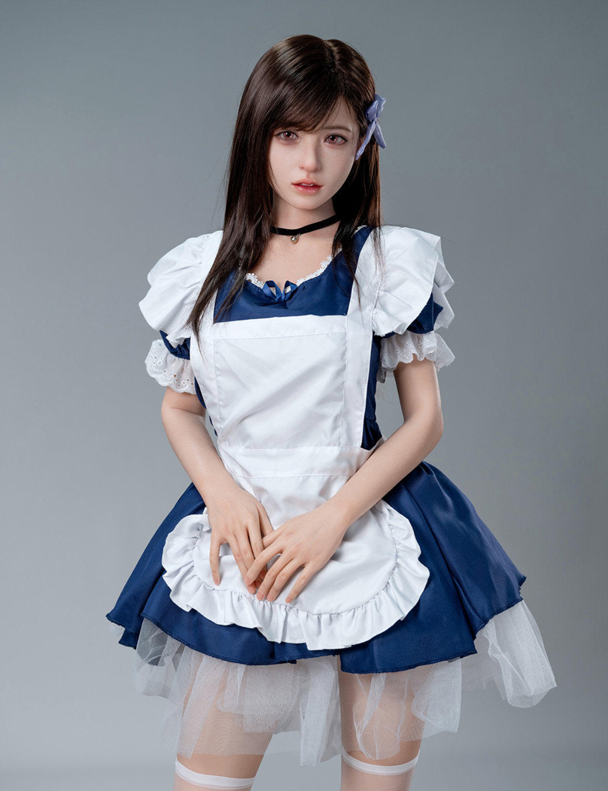 Mid-length front view of the Koharu doll standing in a blue maid outfit with a frilled white apron.