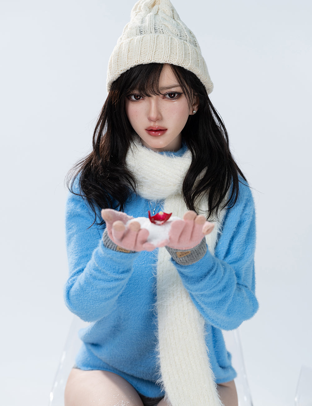 TOP-CYDOLL 168cm F-Cup Bingbing Realistic Sex Doll wearing a blue sweater, white scarf, and cream hat holding a small red object against a light gray background