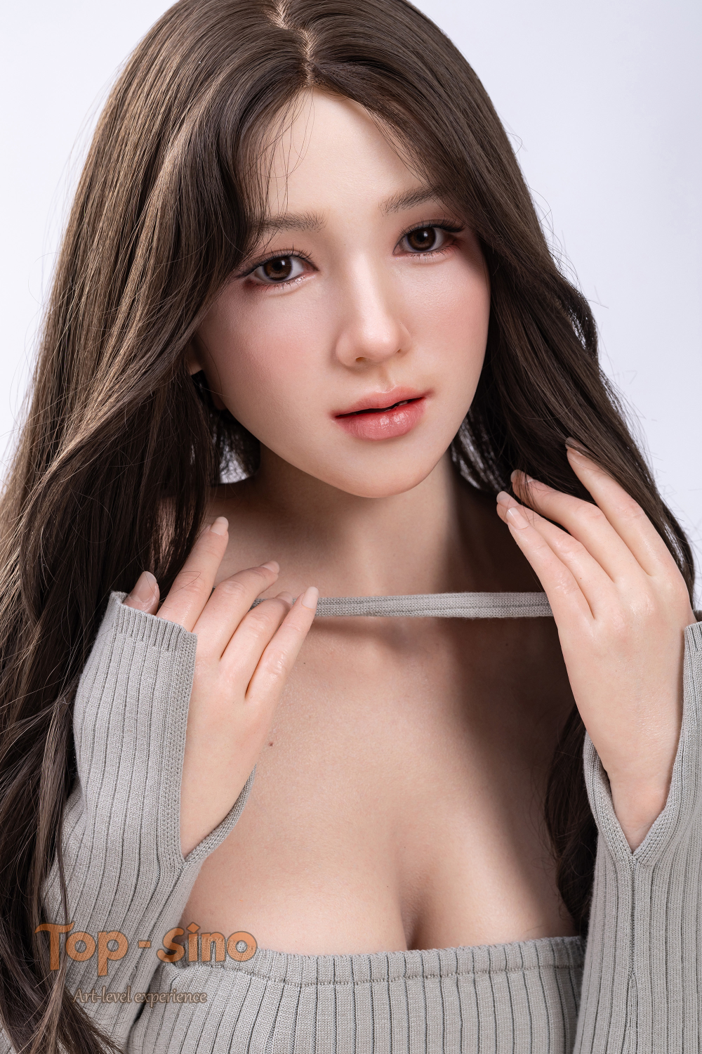 Top Sino 167 cm Platinum Silicone - Miyan (RRS+) in gray top long sleeve holding a strip of cloth against her chest.