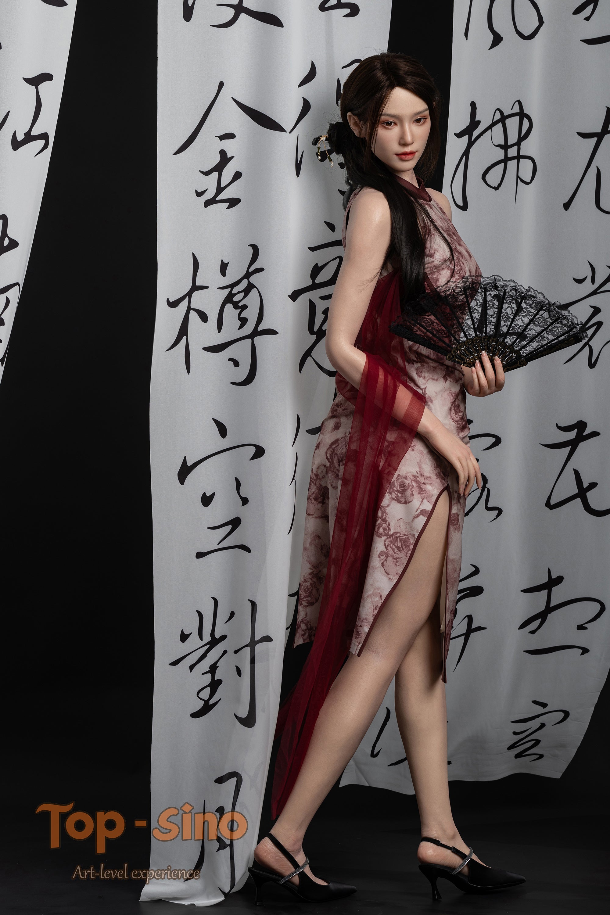 Top Sino 167 cm Platinum Silicone - Mishi (RRS+) in a red palette sexy dress holding a black fan against a white curtain with black Chinese calligraphy.