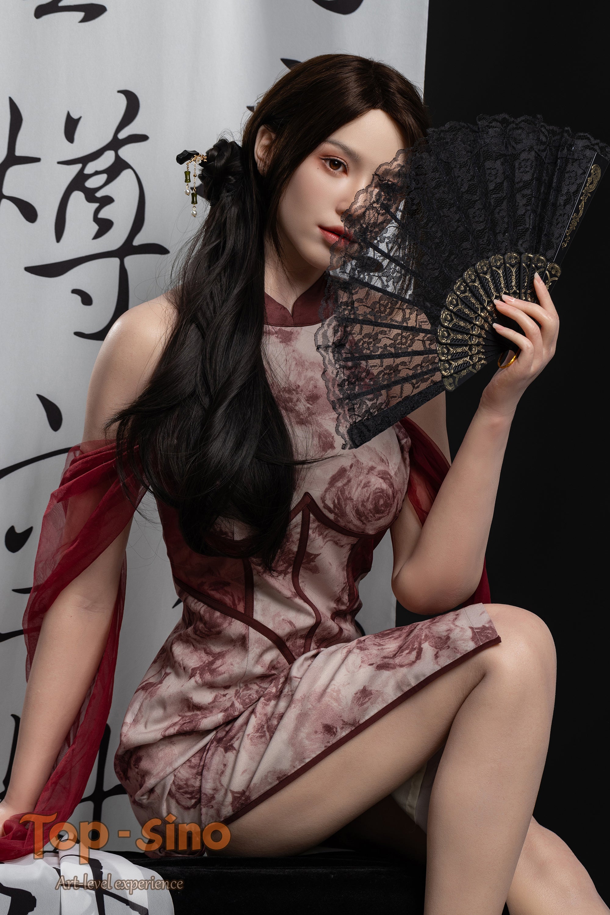 Top Sino 167 cm Platinum Silicone - Mishi (RRS+) in a traditional red dress holding a fan against a white curtain with Chinese characters painted in black.