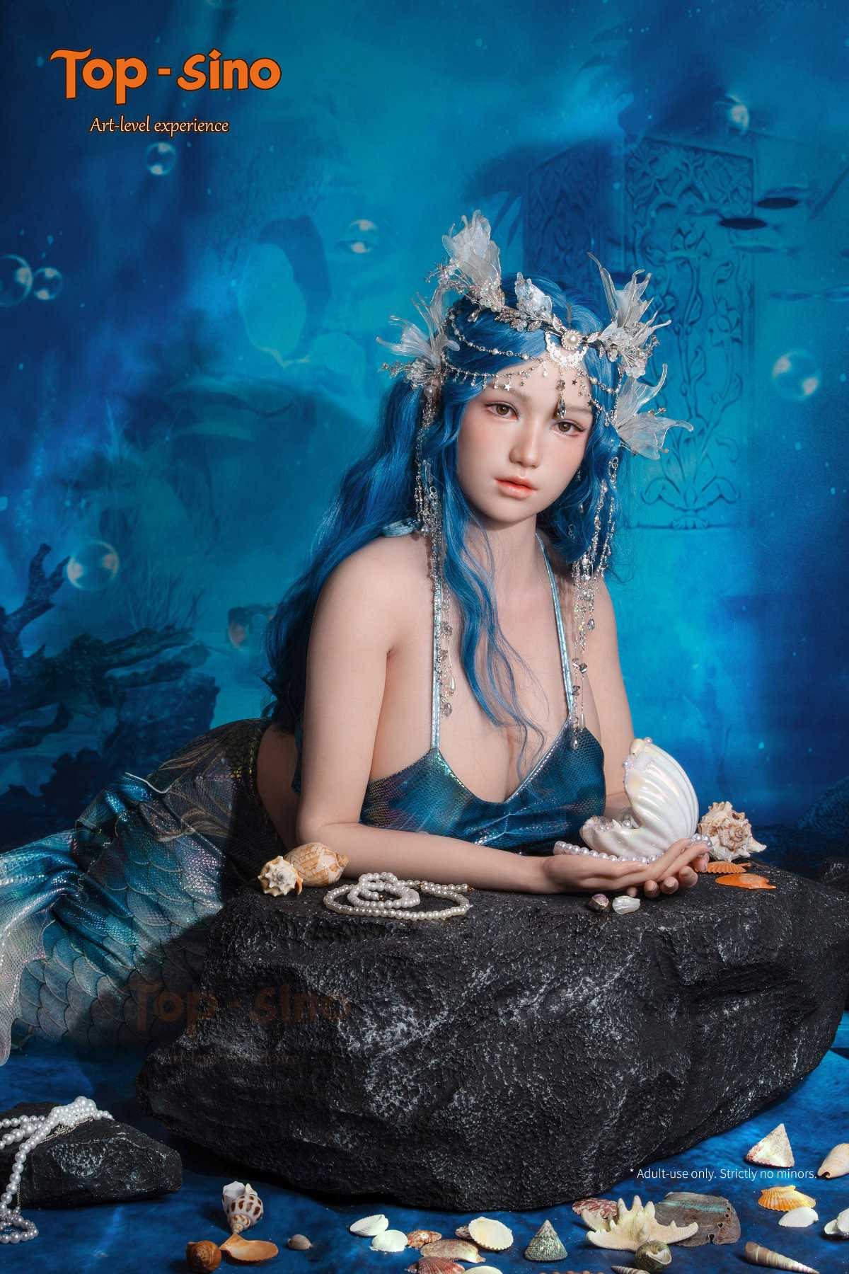 Top Sino Torso T96 cm Platinum Silicone Recreated Series - Misu (RRS+) with blue hair and mermaid-themed costume leaning on a rock with a blue underwater background.