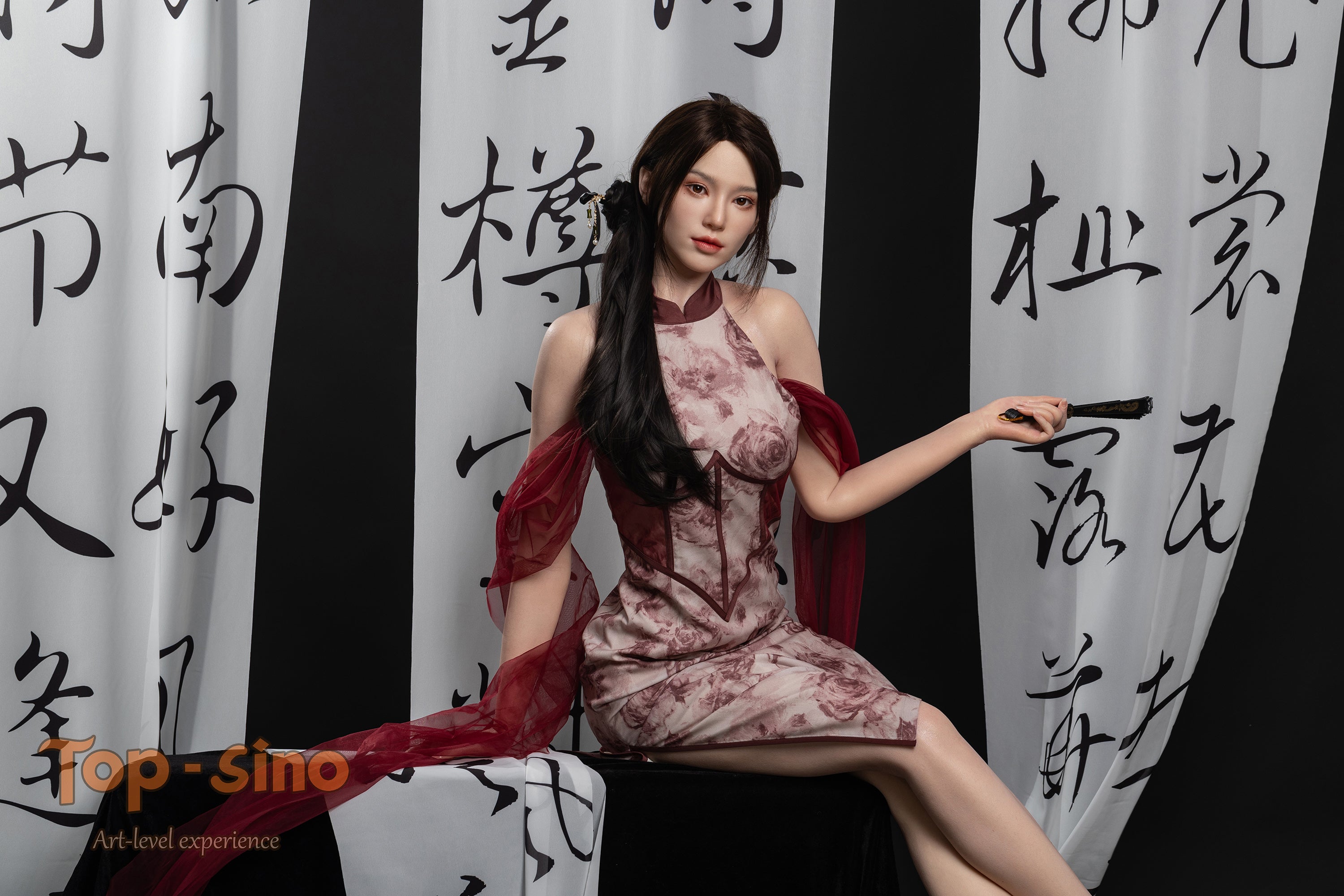 Top Sino 167 cm Platinum Silicone - Mishi (RRS+) sitting on a black table with black painted calligraphy in the background