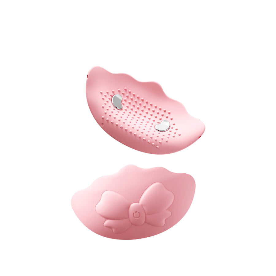 Soft pink wearable vibrator with textured surface and ergonomic curved design