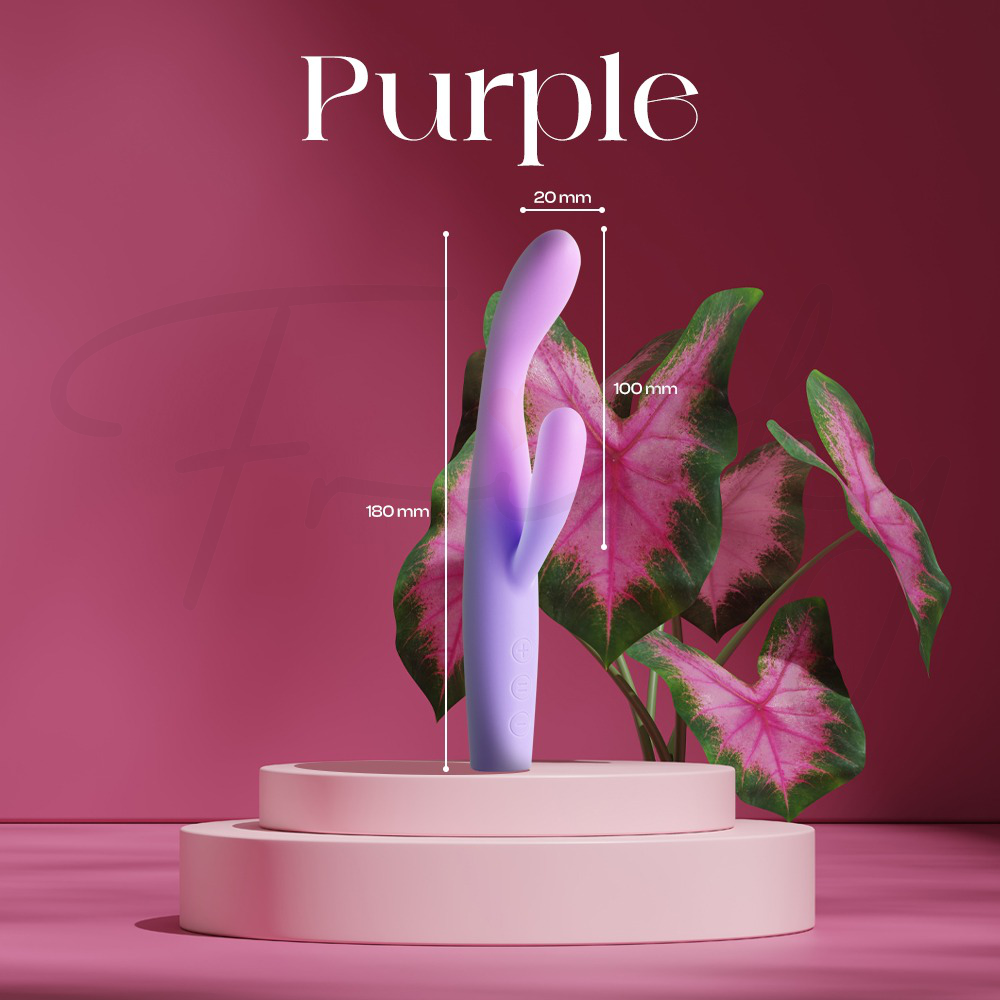 This image displays a purple and light-violet gradient dual-stimulation vibrator resting on a tiered pink pedestal surrounded by pink-veined tropical leaves. The diagram highlights the product's specifications, including a total height of 180 mm, a width of 20 mm, and a notably longer secondary stimulator measuring 100 mm.