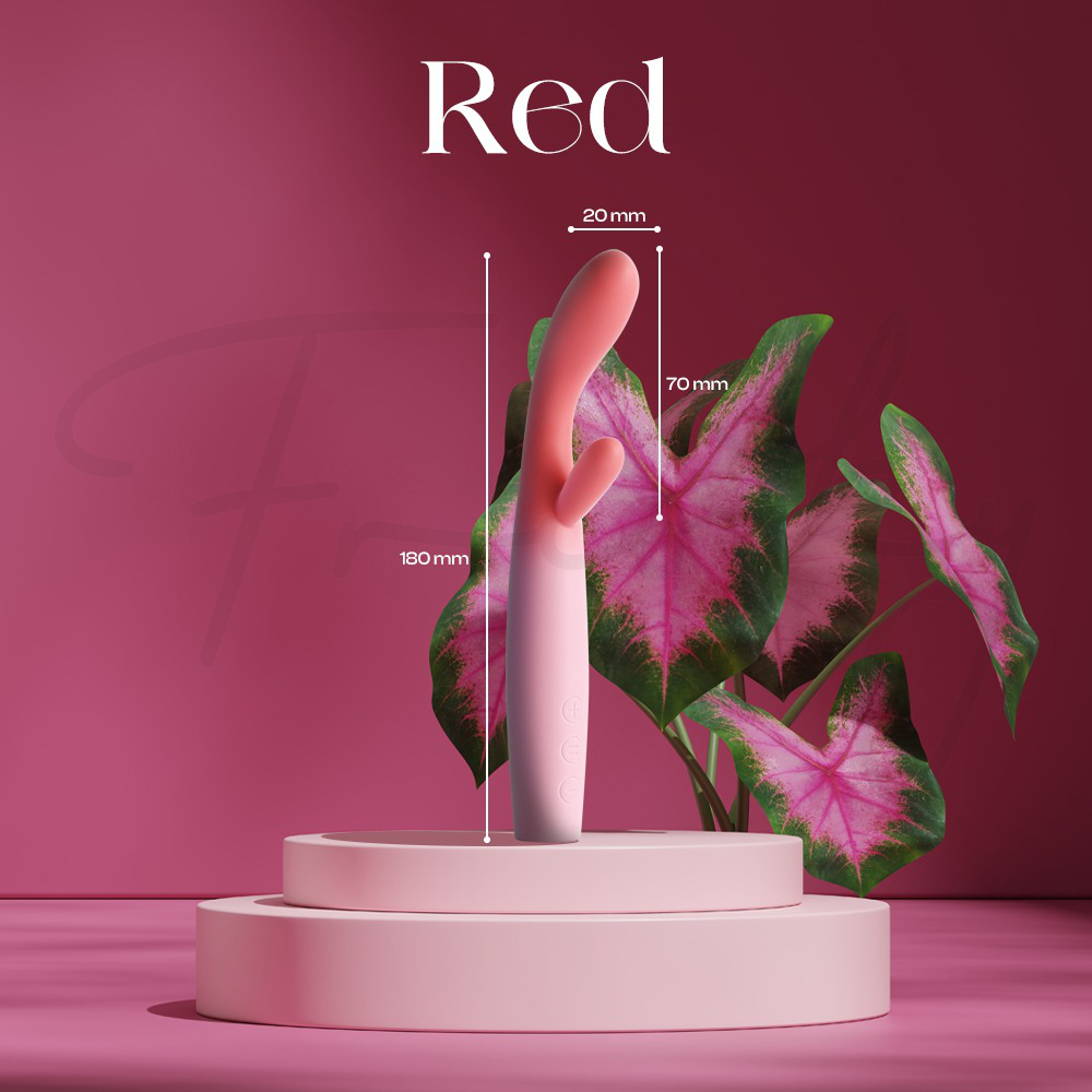 This image features a dual-stimulation vibrator with a red and pink gradient, displayed prominently on a pink circular pedestal against a background of tropical green and pink foliage. Technical dimensions are indicated by white lines, showing a total height of 180 mm, a tip width of 20 mm, and a secondary stimulator length of 70 mm.