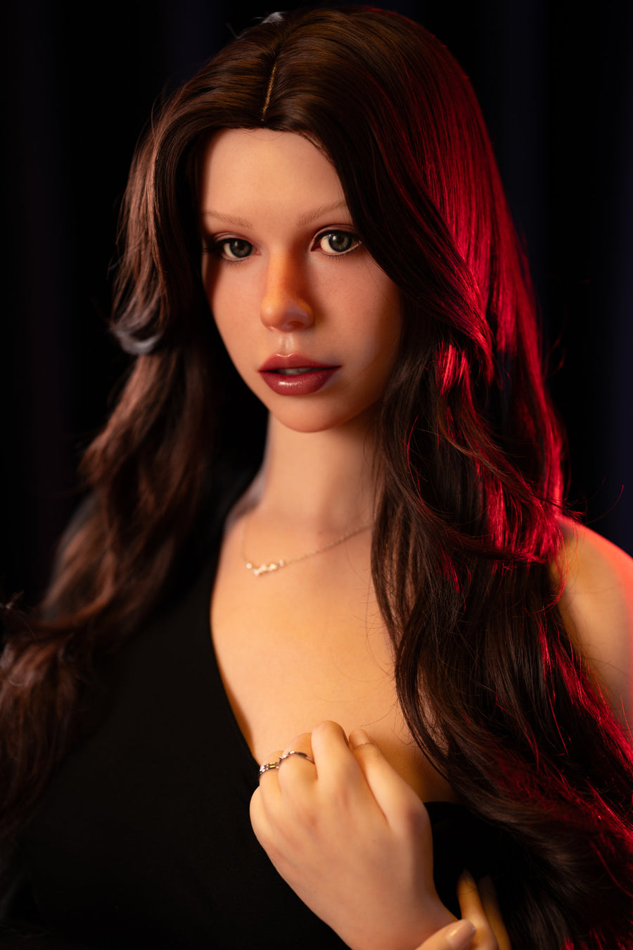 Zelex Doll Inspiration 165 cm F Silicone - GE181 close-up upper body nude shot, long dark wavy hair, dark dramatic background with red lighting
