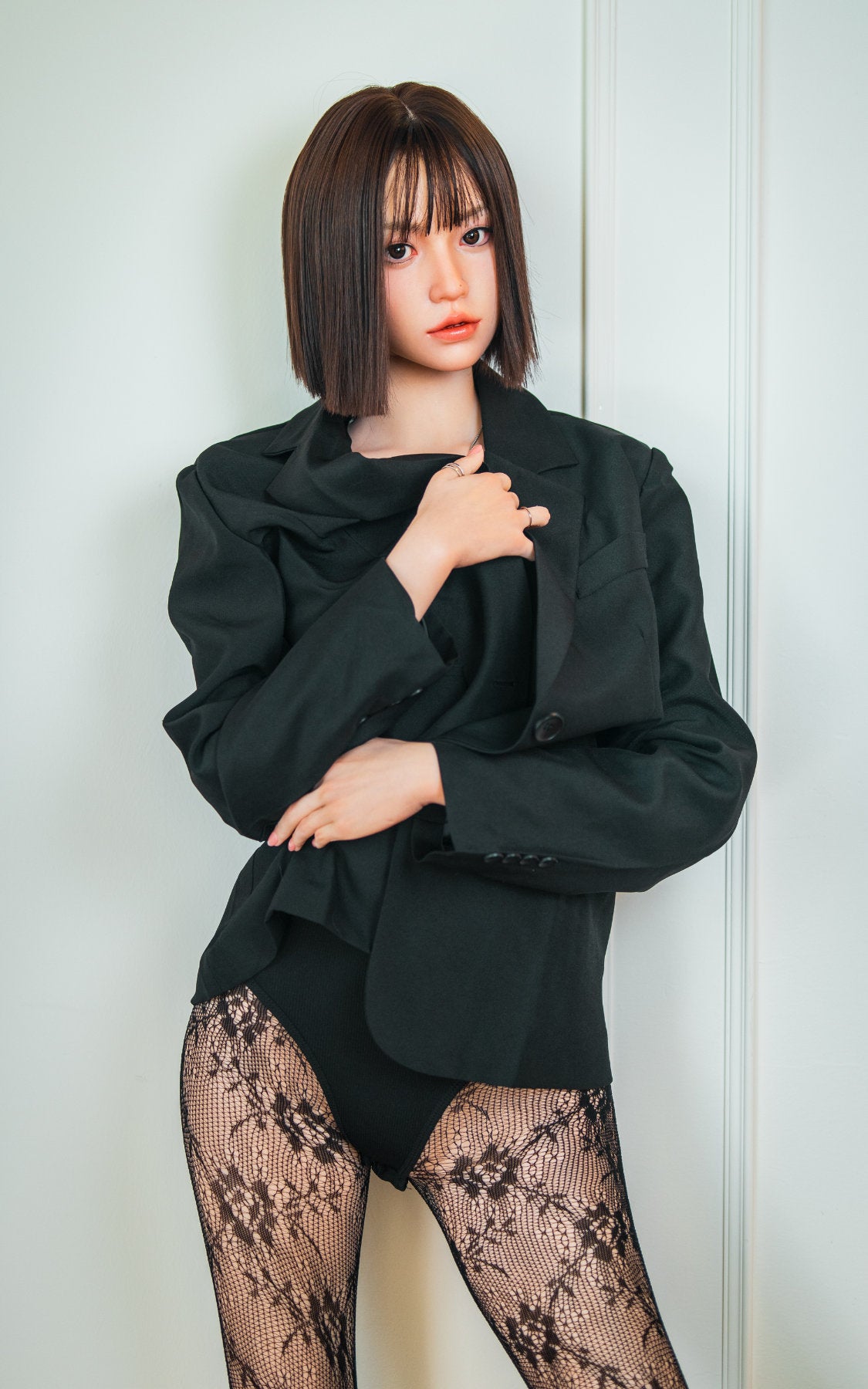 Zelex Doll K-Series 168 cm B Silicone - Arin upper body side view in black oversized blazer, short dark bob hair, white studio background
