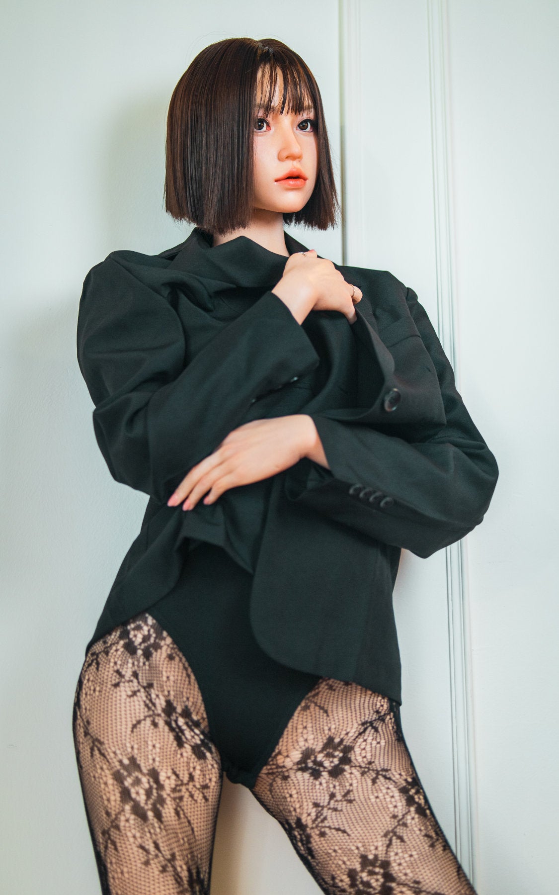 Zelex Doll K-Series 168 cm B Silicone - Arin full body rear view in black oversized blazer and lace patterned stockings, short dark bob hair, white studio background
