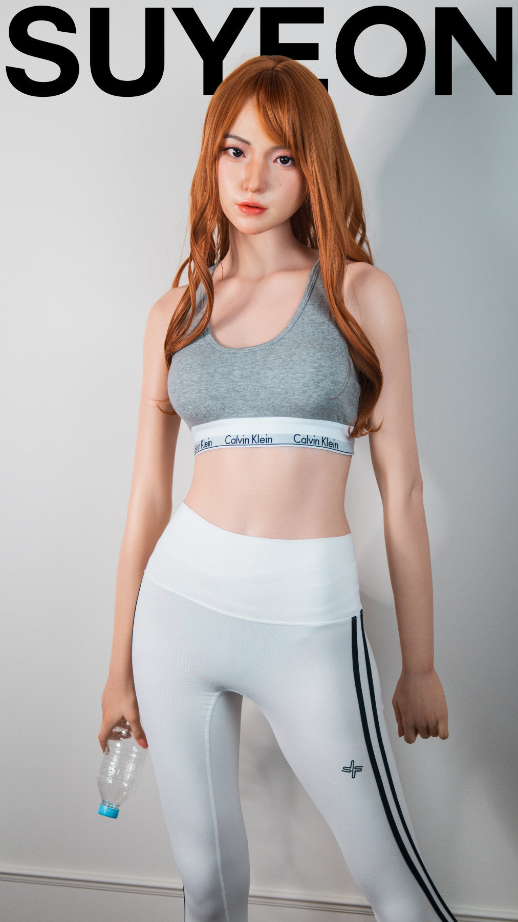 Zelex Doll K-Series 168 cm B Silicone - Suyeon full body standing pose in grey sports bra and white athletic leggings with water bottle, long auburn hair, white studio background
