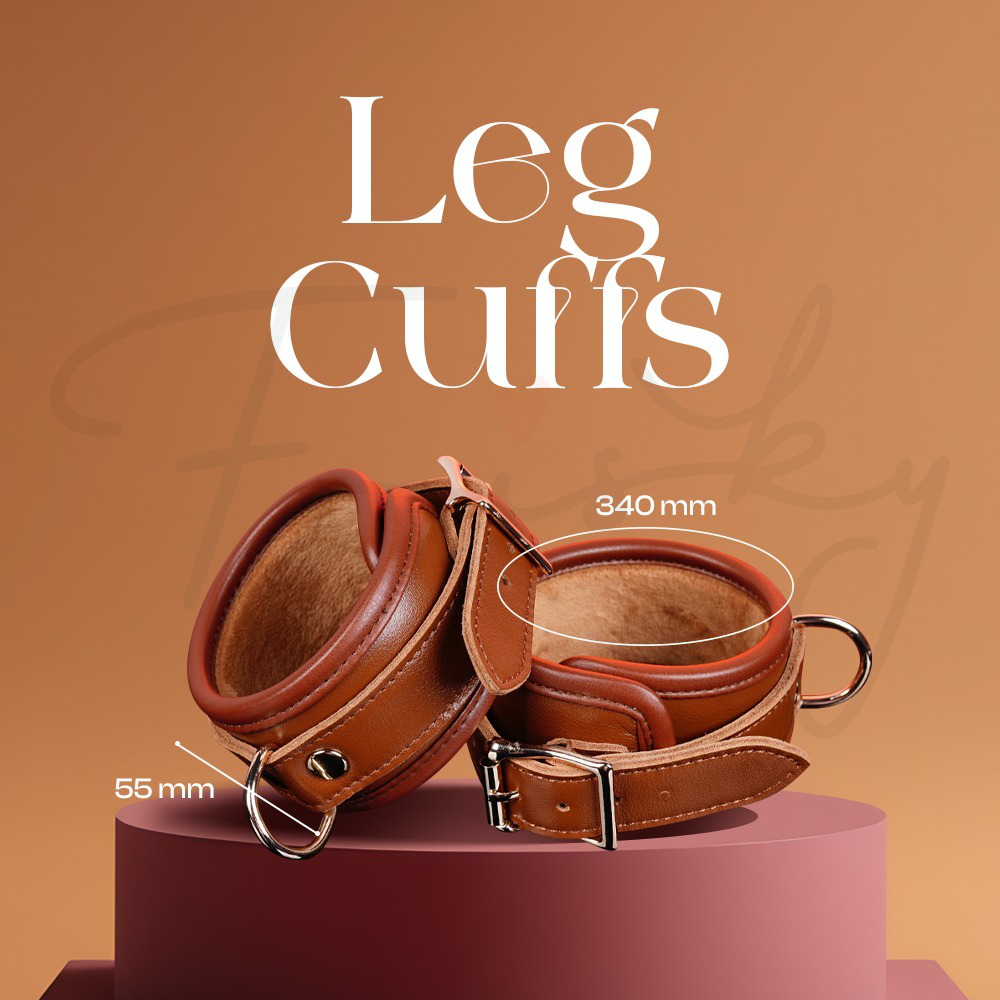 Brown leather leg cuffs on a pink platform with measurements indicated, against a brown background.