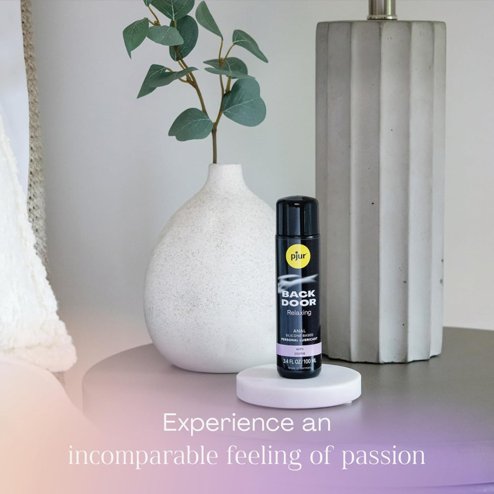 Personal lubricant spray bottle displayed in an elegant bathroom-inspired setting.