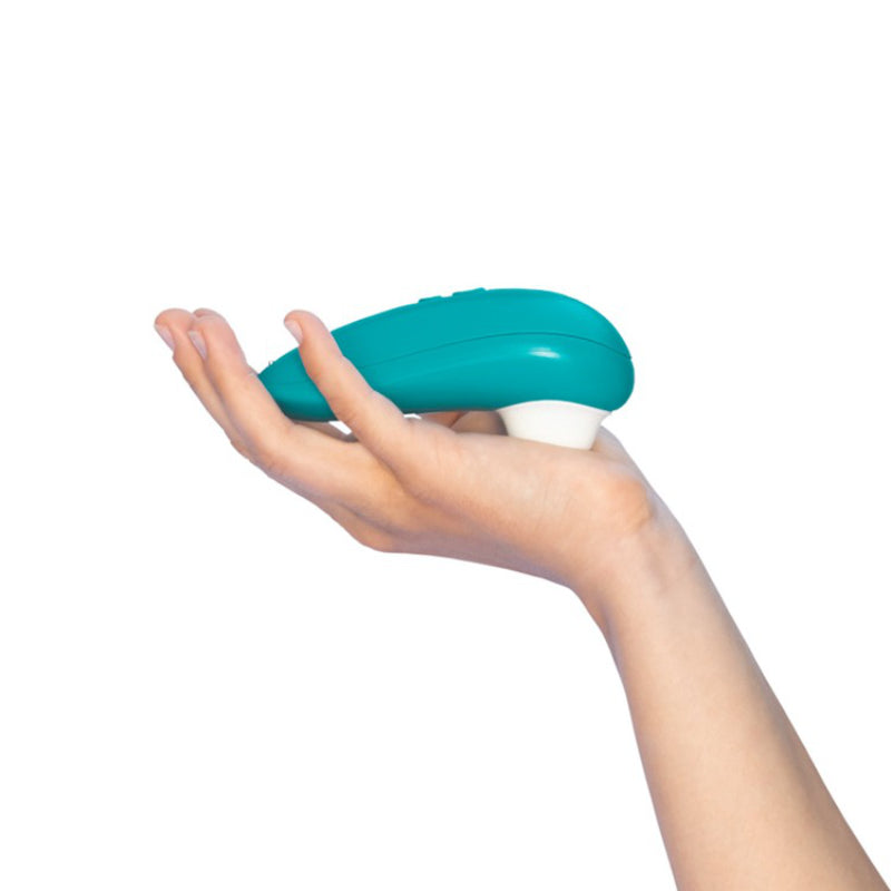 Open palm holding the turquoise Womanizer Starlet 3, showing how compact it is