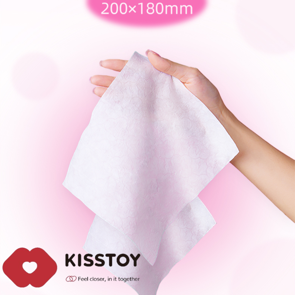 Hands holding a white wipe above the Kisstoy red lip logo on a pink background