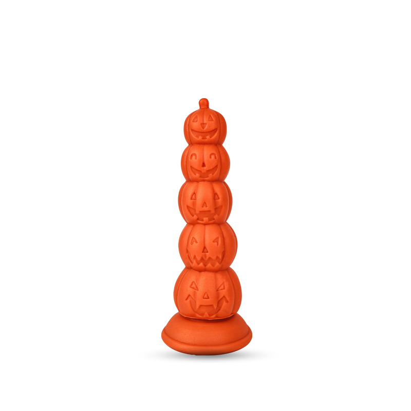 Orange stacked plug of carved pumpkin segments with a flared suction base on white background